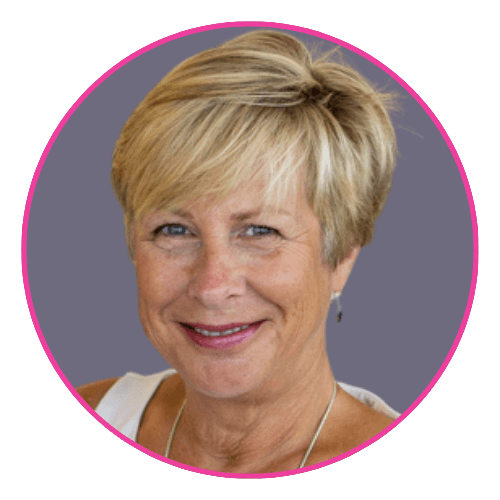 Jane Hatton smiling against a muted purple background, wearing a white top and silver necklace.