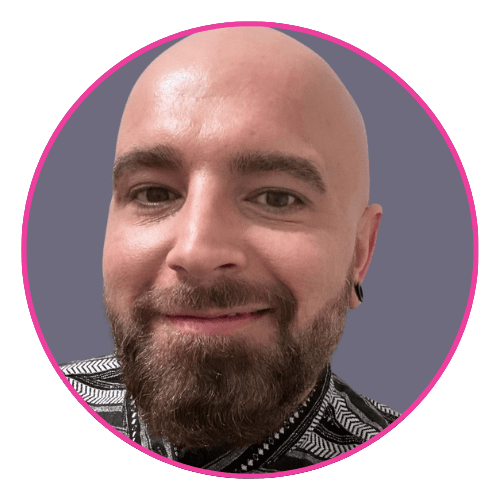 David with a full beard and bald head, wearing a black and white patterned shirt.