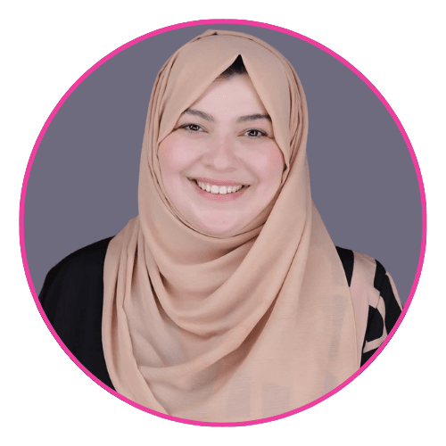 Samar smiling, wearing a beige hijab and black outfit with patterned sleeves.